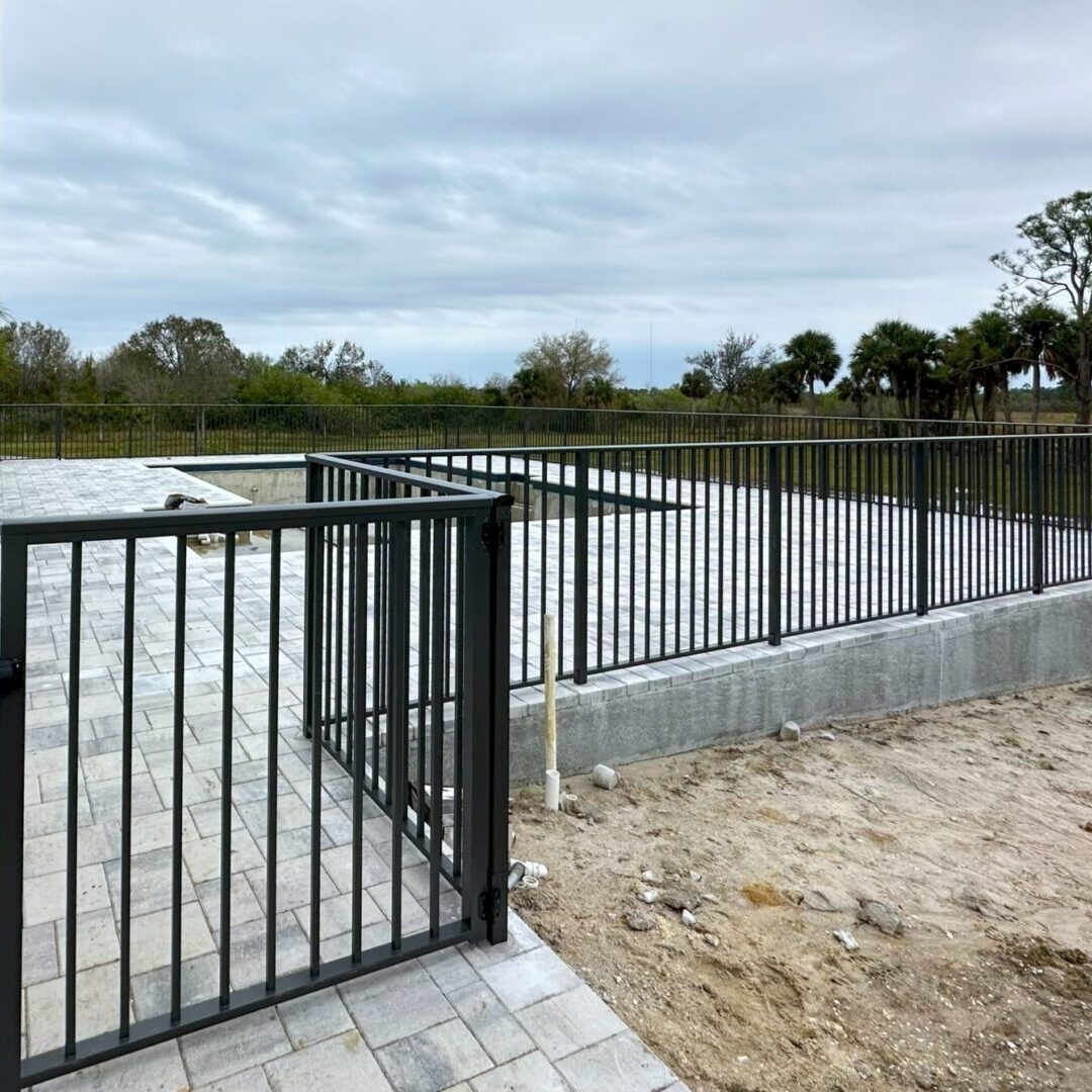 A fence that has some kind of metal gate on it